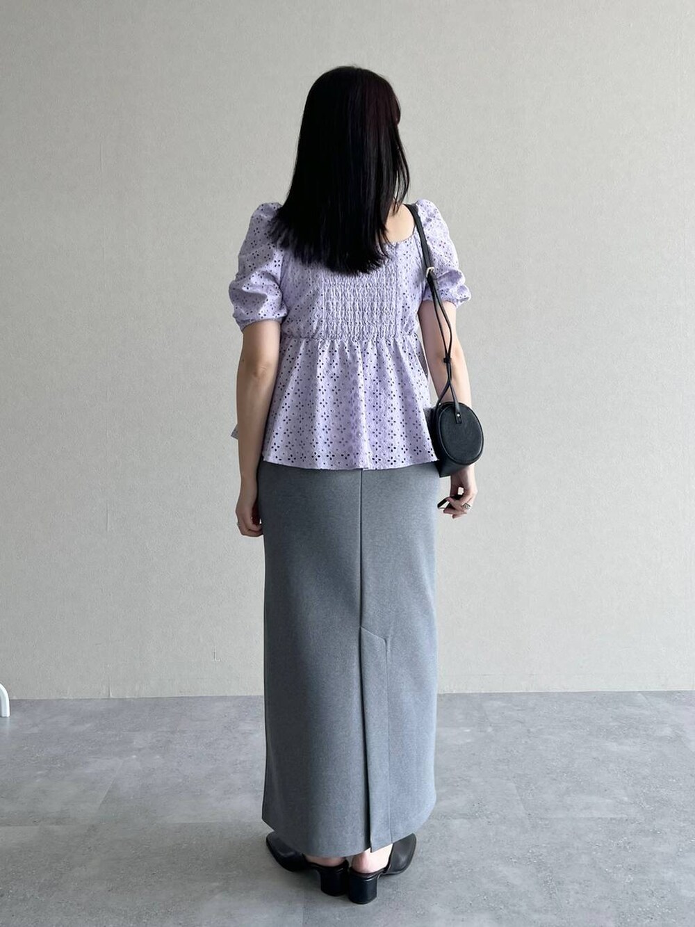 ブラック系のショルダーバッグ、グレー系のスカート、パープル系のシャツ/ブラウスを着用したレディースの夏コーディネートの3枚目の写真