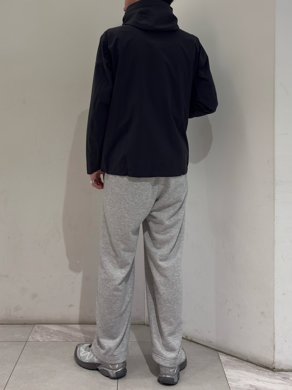 ブラック系のテーラードジャケット、グレー系のその他パンツ、シルバー系のスニーカーを着用したメンズの春コーディネートの6枚目の写真