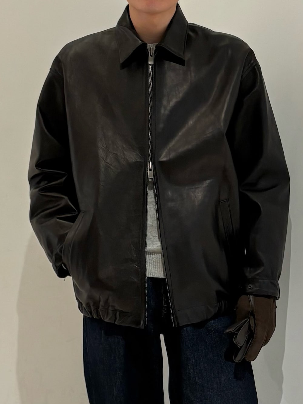 ブラック系のテーラードジャケット、ブラウン系の手袋を着用したメンズの冬コーディネートの3枚目の写真