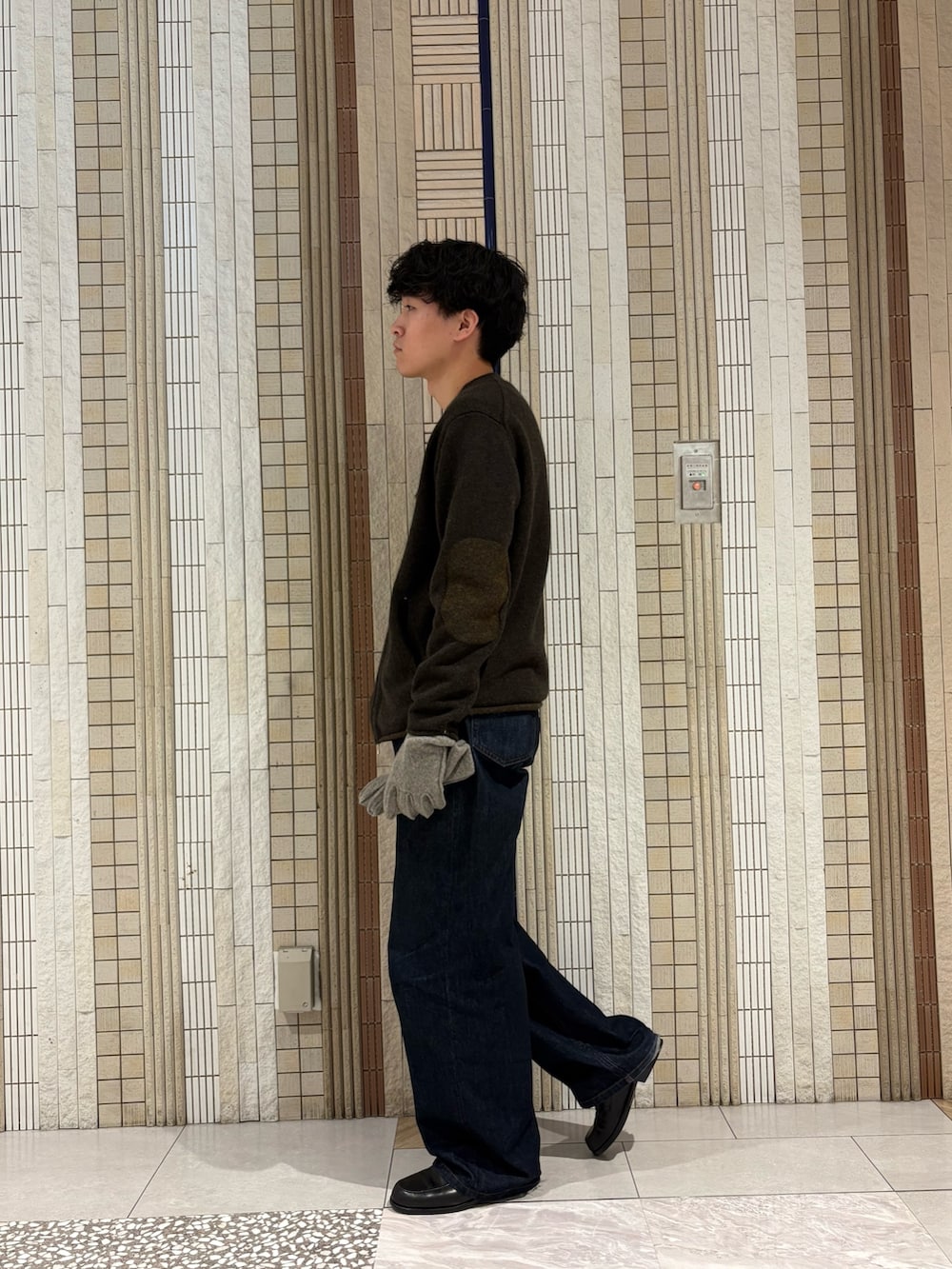 グレー系のニット/セーター、グレー系の手袋を着用したメンズの秋コーディネートの8枚目の写真