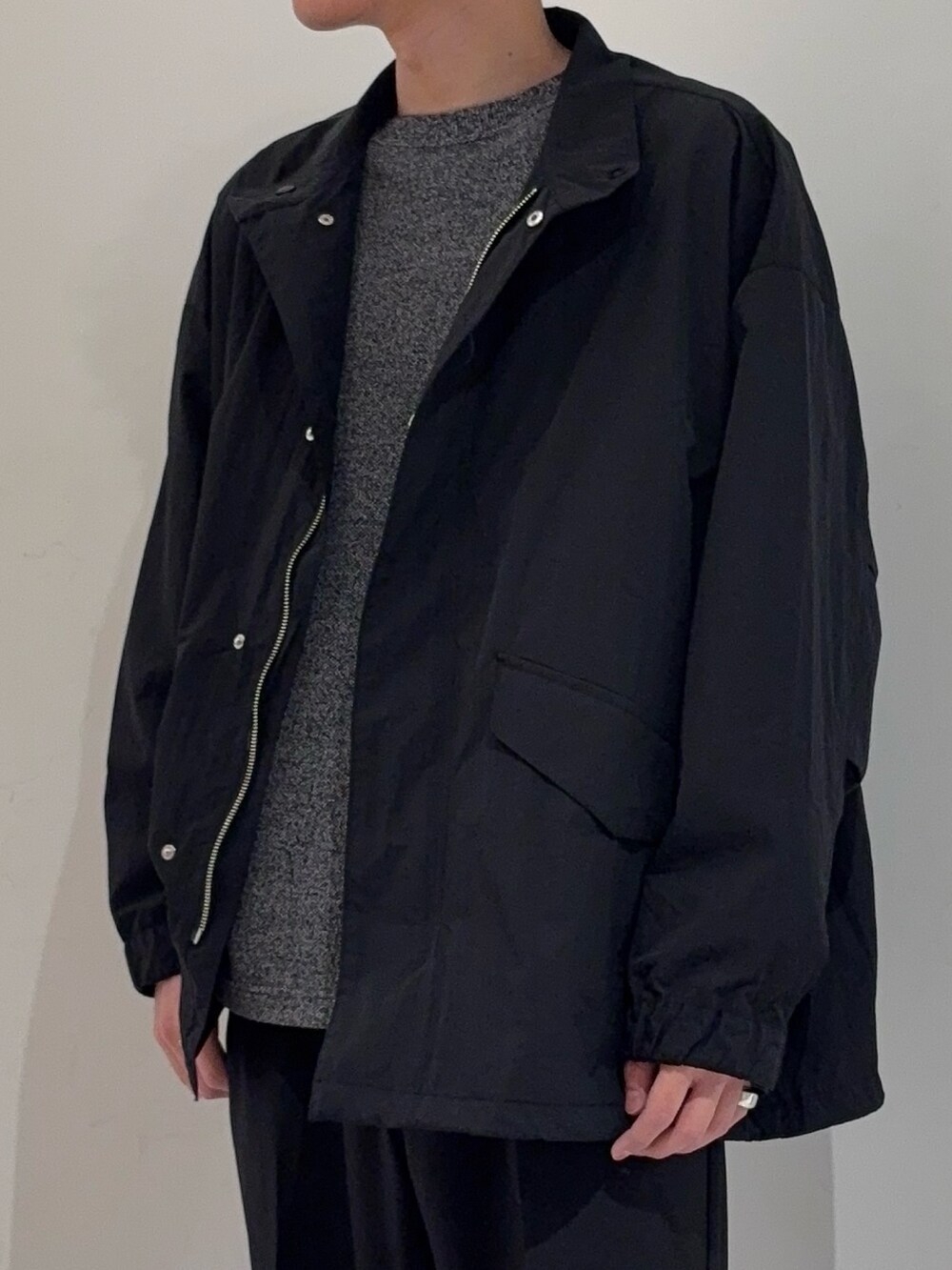 ブラック系のその他アウター、グレー系のニット/セーター、ブラック系のその他パンツを着用したメンズの冬コーディネートの3枚目の写真