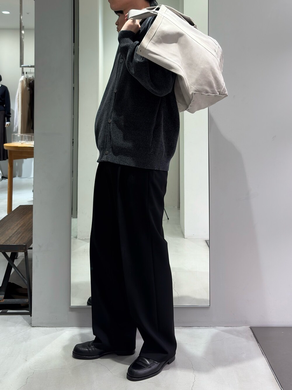 ホワイト系のトートバッグ、グレー系のカーディガン/ボレロ、ブラック系のその他パンツを着用したメンズの秋コーディネートの2枚目の写真