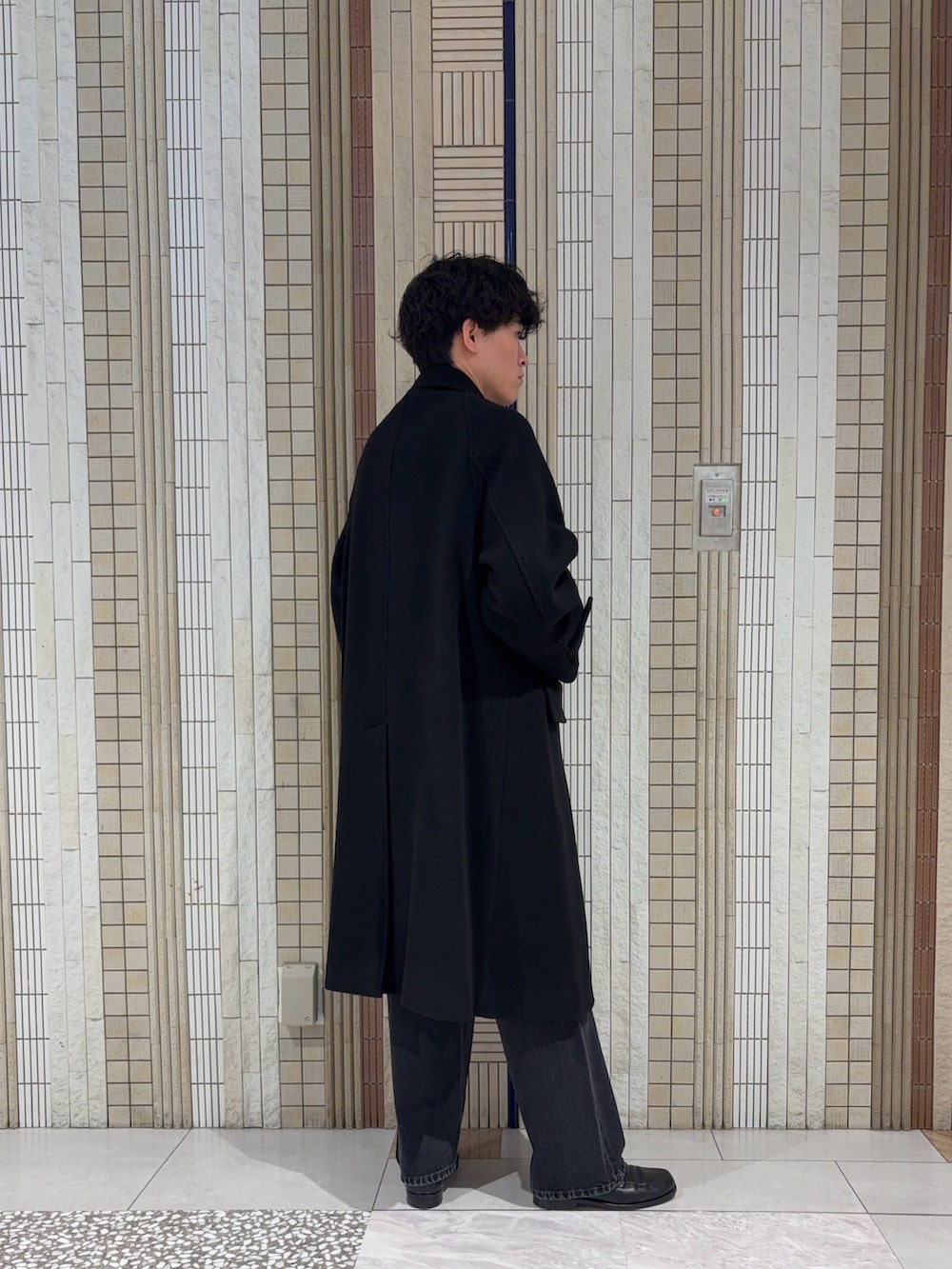 ブラック系のその他アウター、ブラック系のニット/セーター、ブラック系のデニムパンツを着用したメンズの秋コーディネートの7枚目の写真