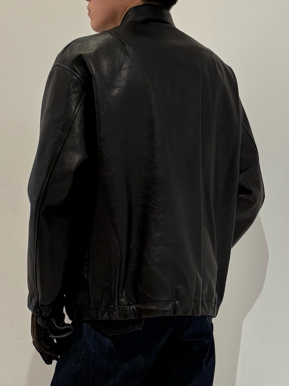 ブラック系のテーラードジャケット、ブラウン系の手袋を着用したメンズの冬コーディネートの8枚目の写真