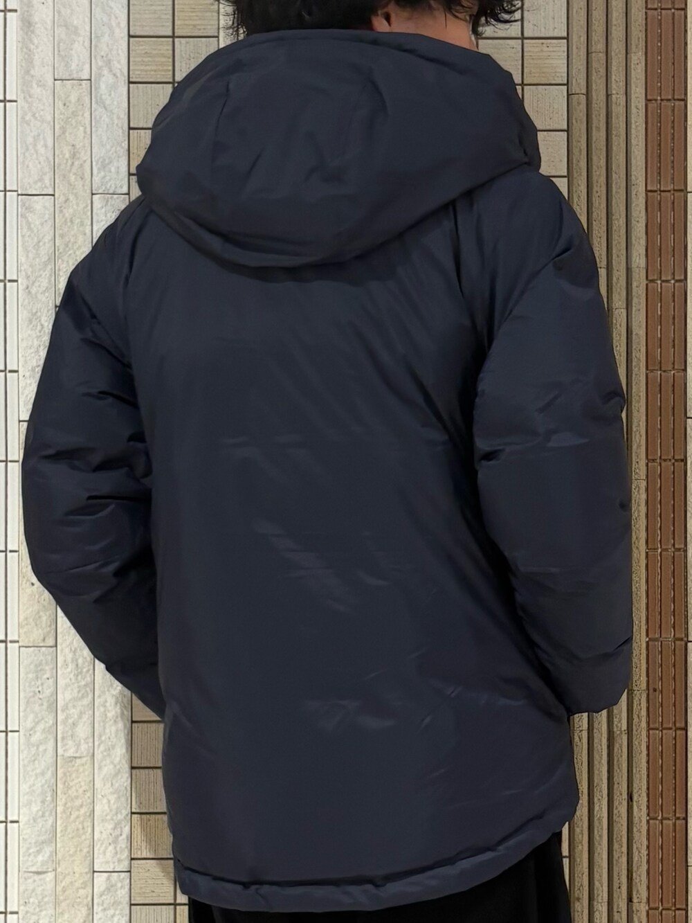 ブルー系のダウンジャケット/コート、パープル系のニット/セーター、ブルー系のその他パンツを着用したメンズの秋コーディネートの7枚目の写真