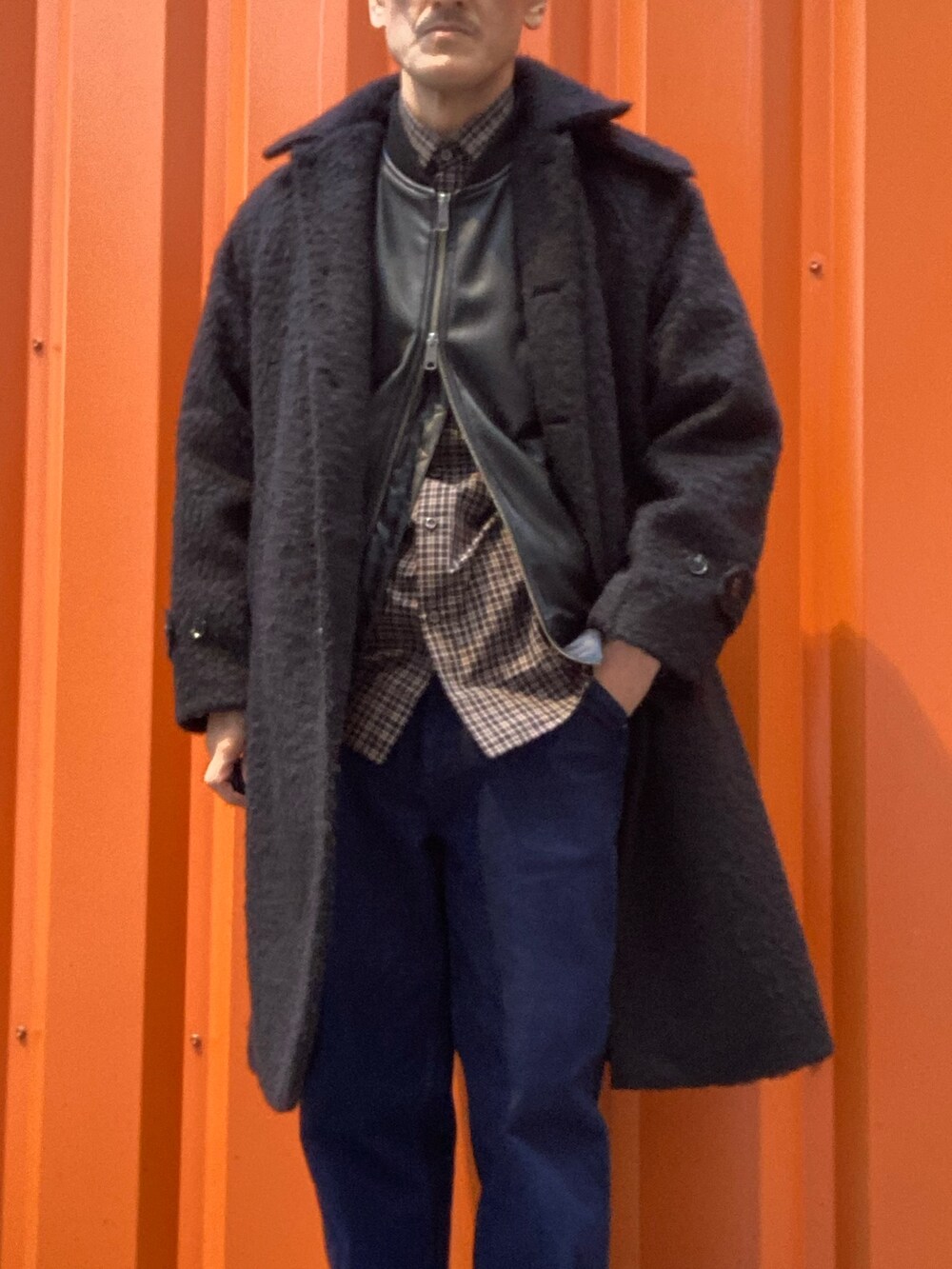 ブラック系のステンカラーコート、ブラック系のライダースジャケット、ブラック系のシャツ/ブラウスを着用したメンズの冬コーディネートの2枚目の写真