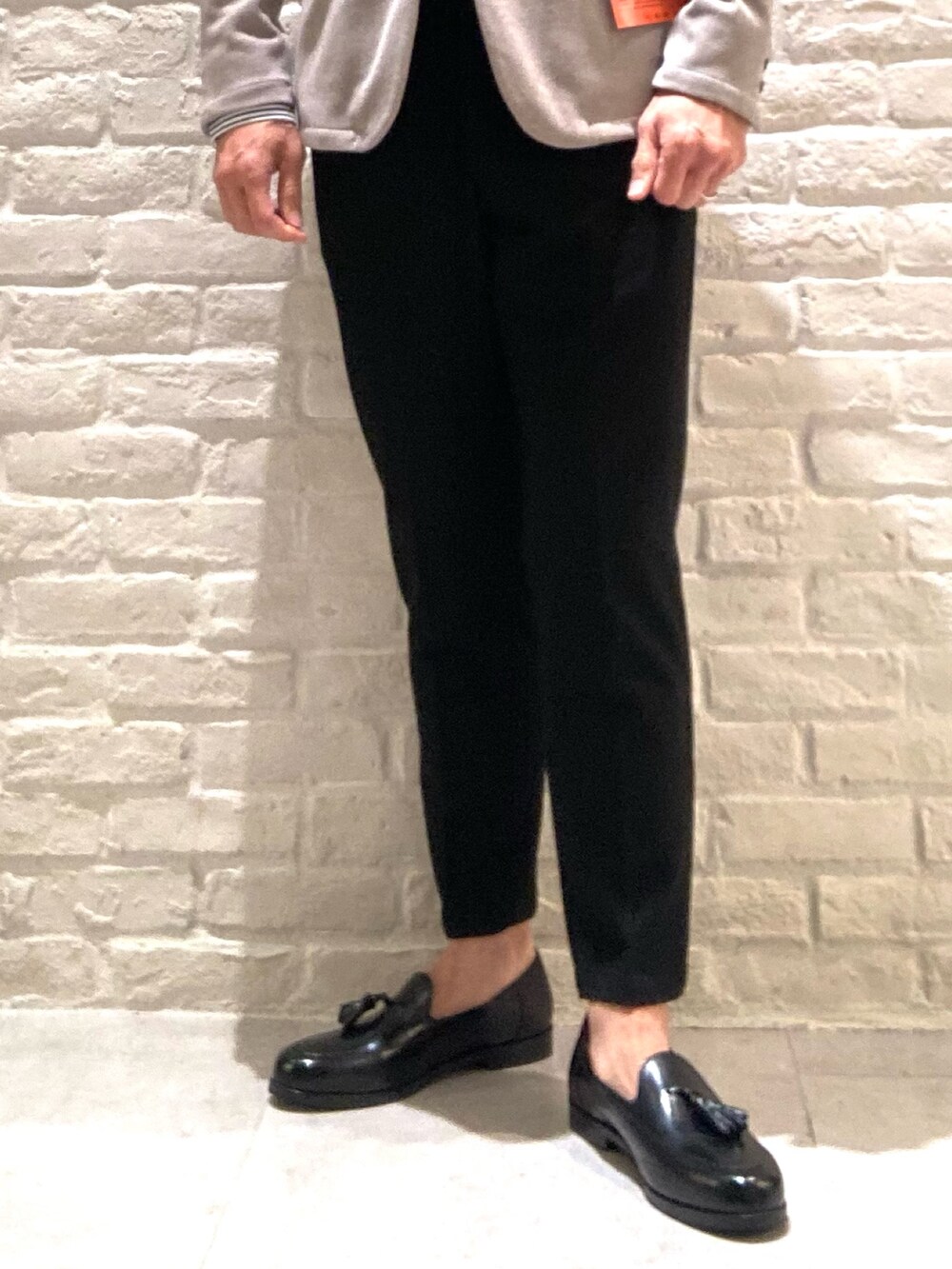 ベージュ系のテーラードジャケット、ブラック系のスラックス、ブラック系のシャツ/ブラウスを着用したメンズの冬コーディネートの4枚目の写真