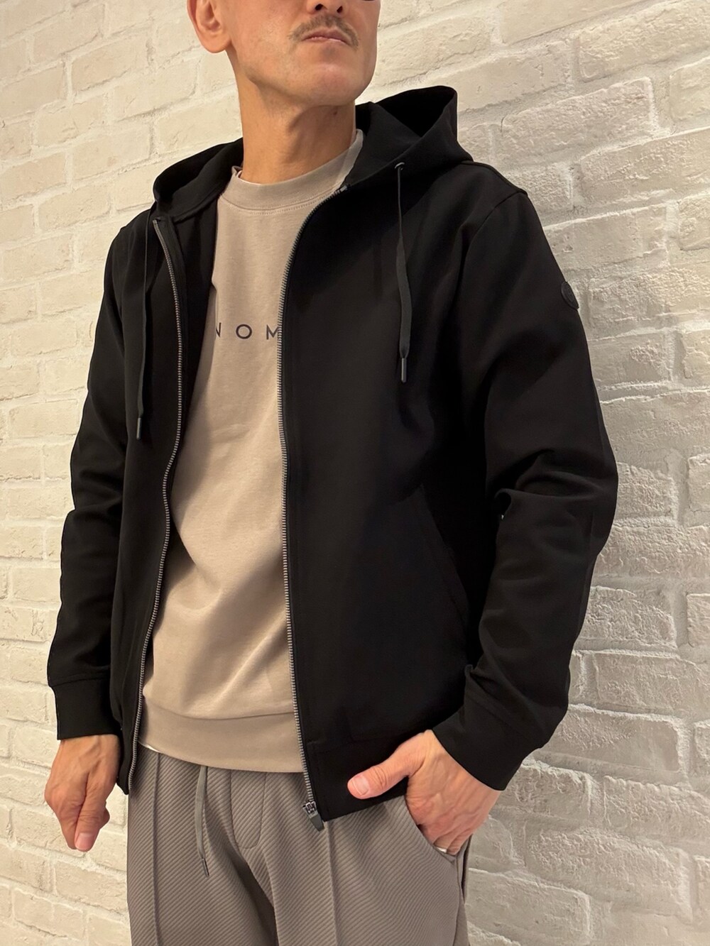 ブラック系のパーカー、ブラウン系のTシャツ/カットソー、グリーン系のその他パンツを着用したメンズの秋コーディネートの3枚目の写真