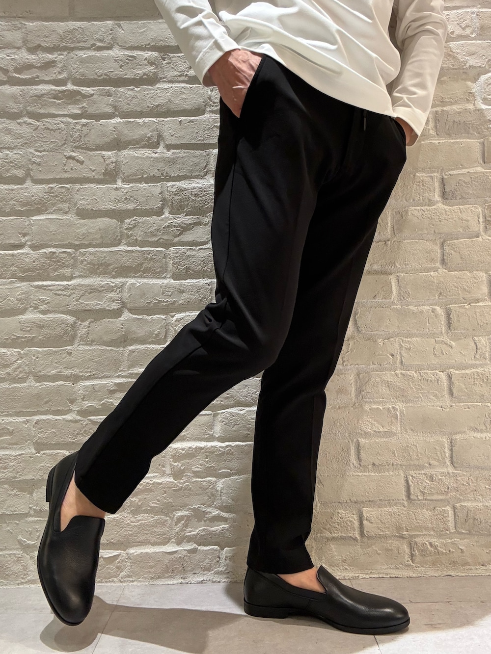 ブラック系のセットアップ、ブラック系のテーラードジャケット、ホワイト系のTシャツ/カットソーを着用したメンズの春コーディネートの4枚目の写真