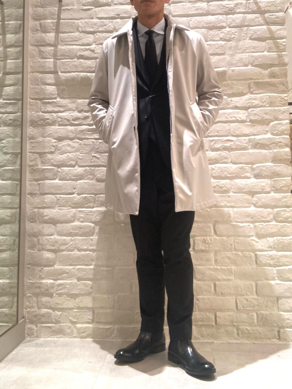 ベージュ系のステンカラーコート、その他のセットアップ、その他のテーラードジャケットを着用したメンズの冬コーディネートの4枚目の写真