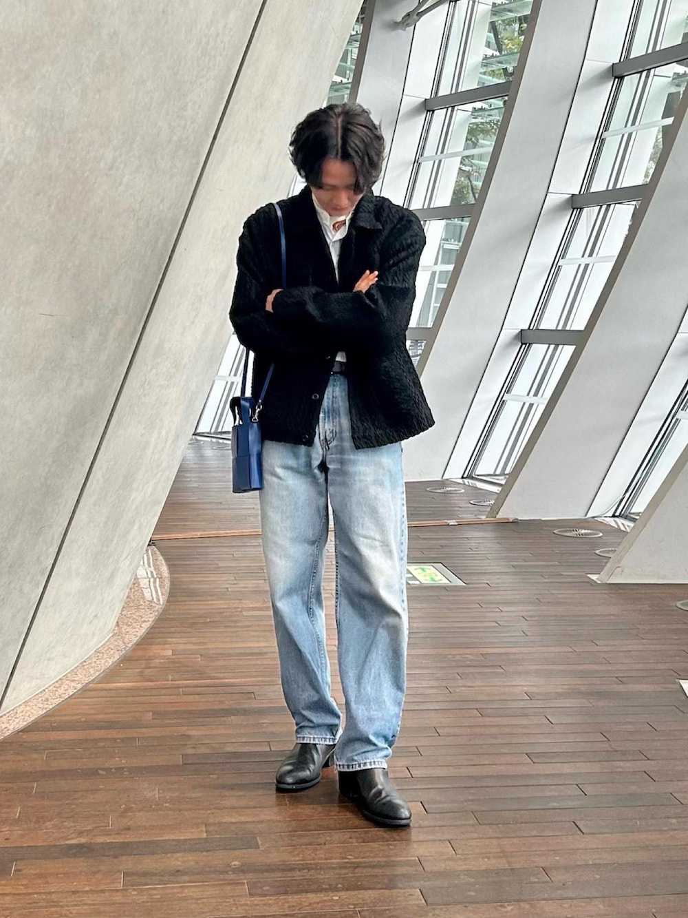 ブルー系のデニムパンツ、ブラック系のドレスシューズ、ブラック系のジャケット/アウターを着用したメンズの秋コーディネートの2枚目の写真