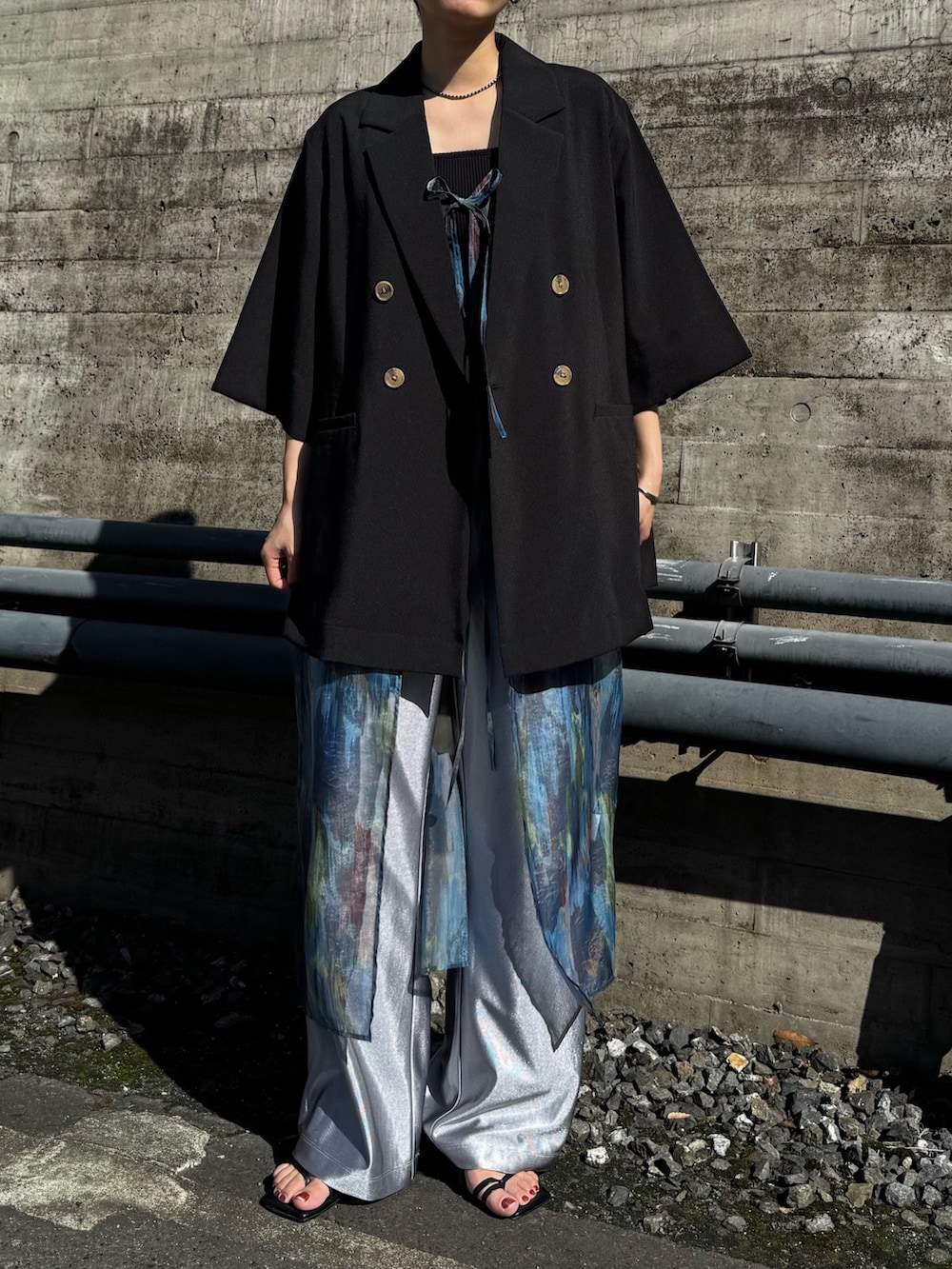 ブラック系のテーラードジャケット、シルバー系のその他パンツ、ブルー系のワンピースを着用したレディースの春コーディネートの5枚目の写真