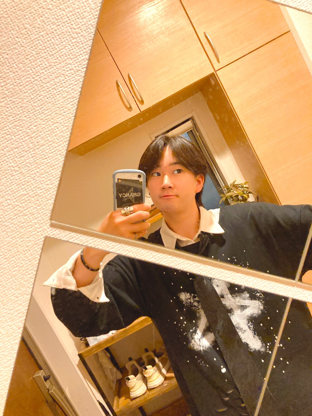 ブルー系のデニムパンツ、グレー系のスニーカー、ブラック系のTシャツ/カットソーを着用したメンズの春コーディネートの2枚目の写真