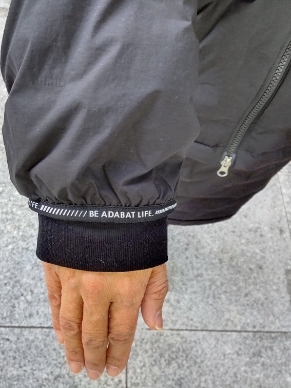 ブラック系のダウンジャケット/コート、ブラック系のスカート、ブラック系のレッグウォーマーを着用したレディースの秋コーディネートの5枚目の写真