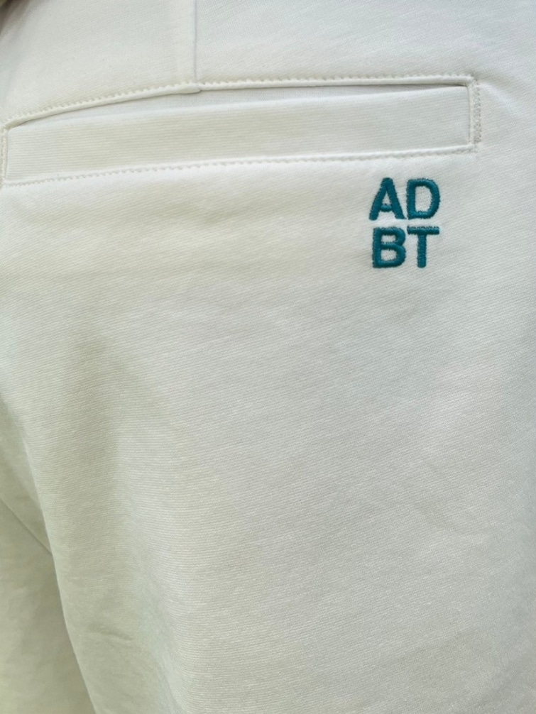 ブルー系のポロシャツ、ホワイト系のその他パンツ、ホワイト系のサンバイザーを着用したレディースの春コーディネートの7枚目の写真