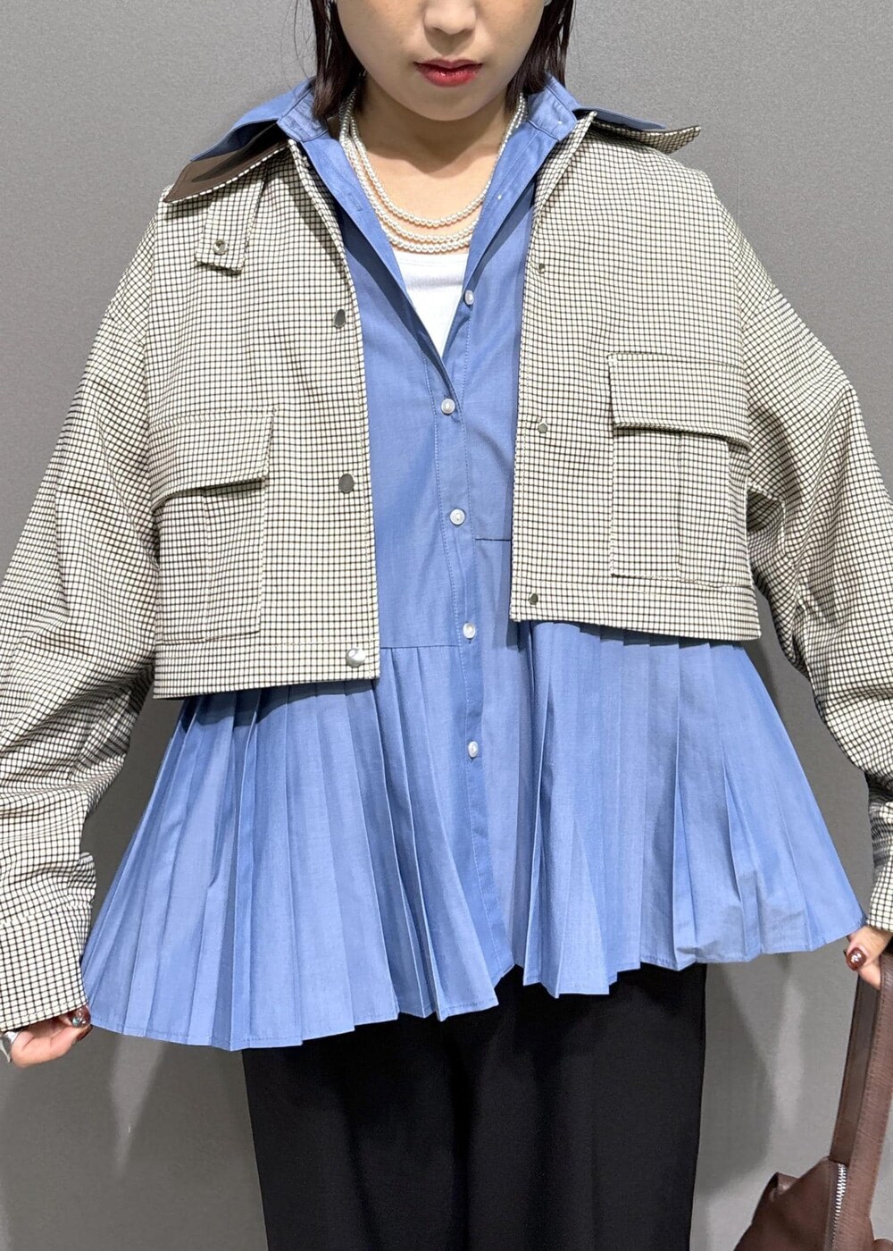 ブラック系のローファー、ブルー系のシャツ/ブラウス、ベージュ系のカバーオールを着用したレディースの秋コーディネートの5枚目の写真