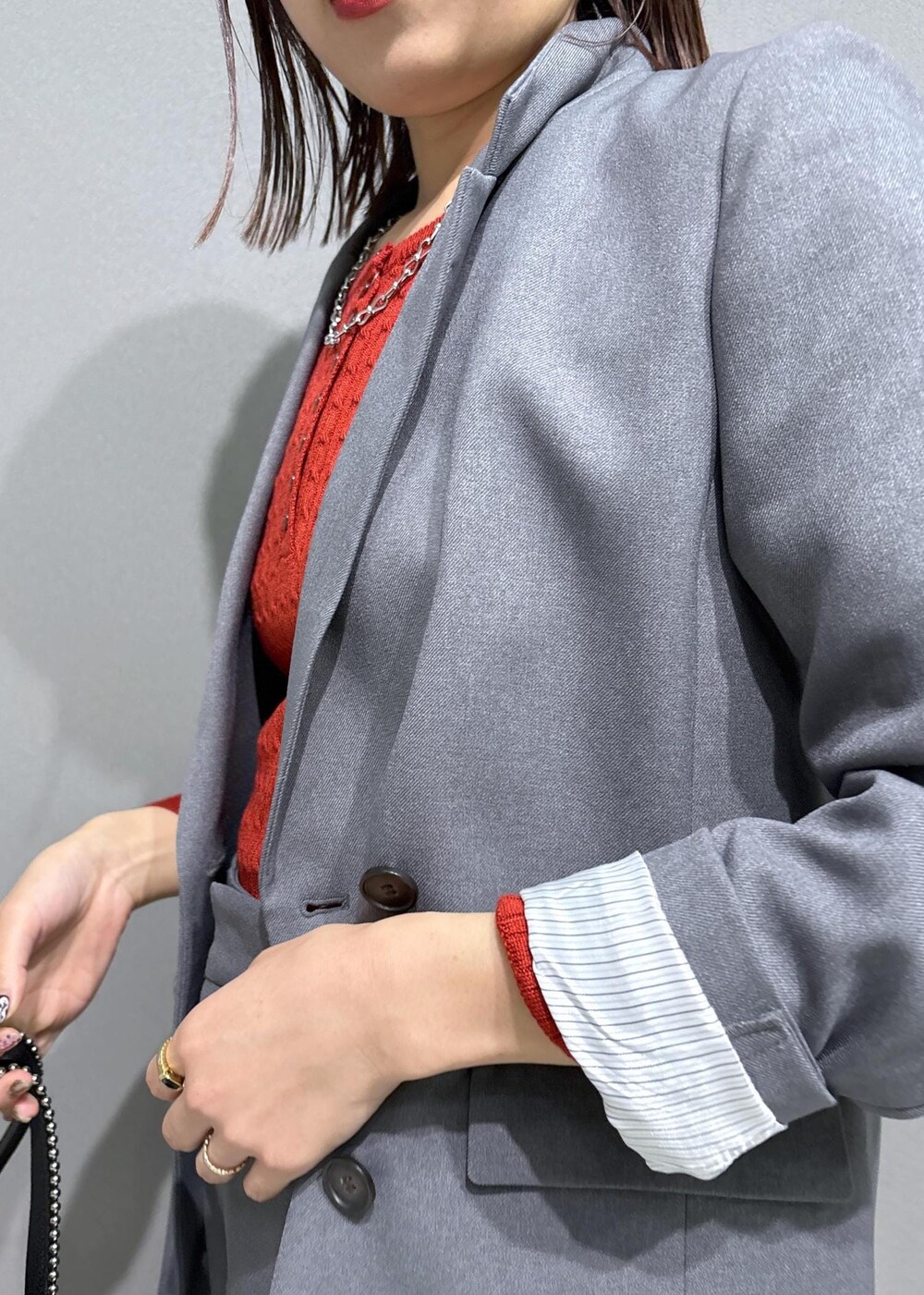 グレー系のスラックス、グレー系のテーラードジャケット、ブラック系のローファーを着用したレディースの秋コーディネートの5枚目の写真