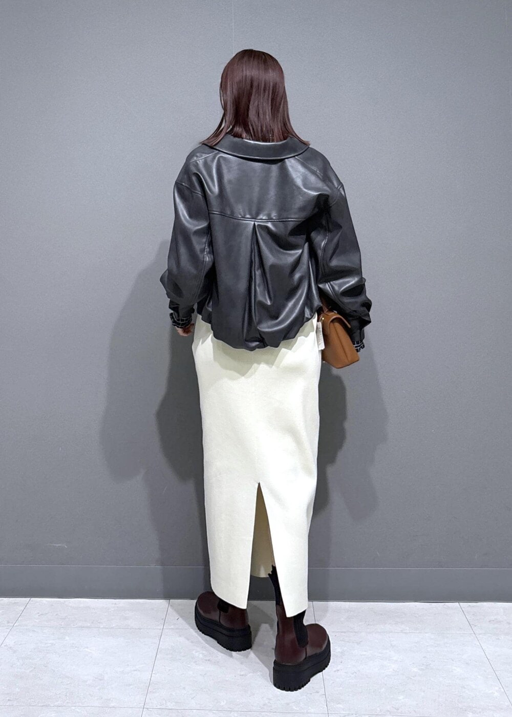 ブラウン系のブーツ、ブラック系のシャツ/ブラウス、ブラック系のブルゾンを着用したレディースの冬コーディネートの3枚目の写真