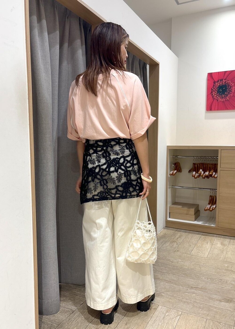 ホワイト系のサンダル、ブラック系のスカート、ホワイト系のデニムパンツを着用したレディースの夏コーディネートの3枚目の写真