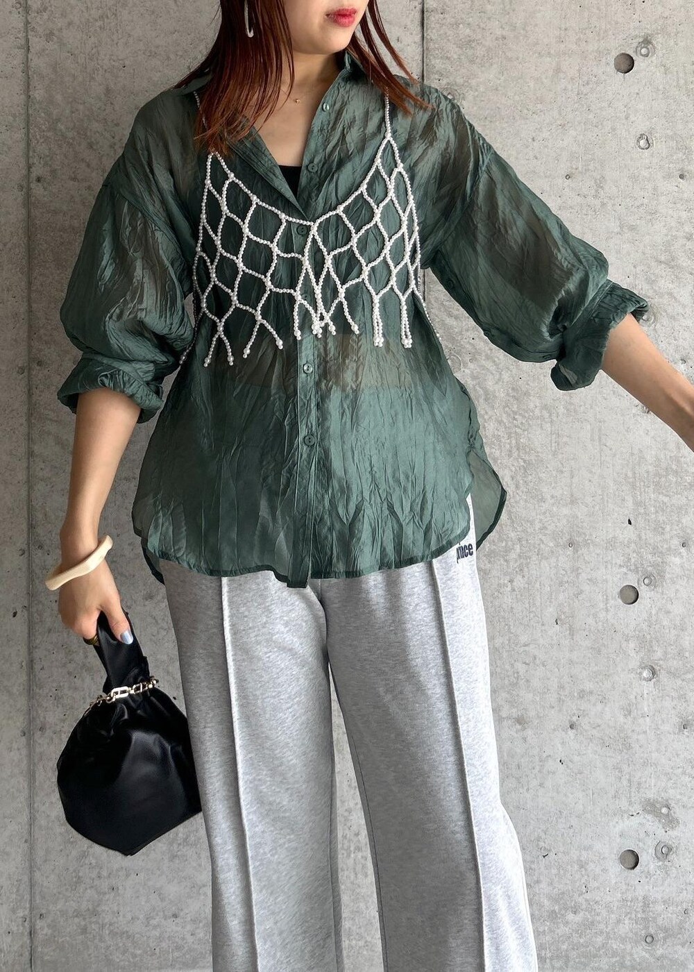 その他のサンダル、グリーン系のシャツ/ブラウス、ブラック系のハンドバッグを着用したレディースの夏コーディネートの4枚目の写真