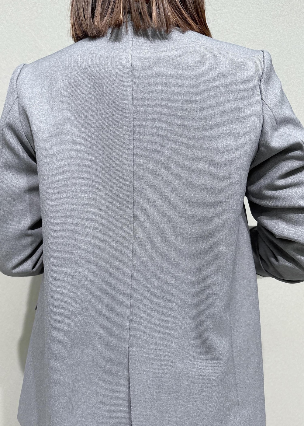 グレー系のスラックス、グレー系のテーラードジャケット、ブラック系のローファーを着用したレディースの秋コーディネートの6枚目の写真