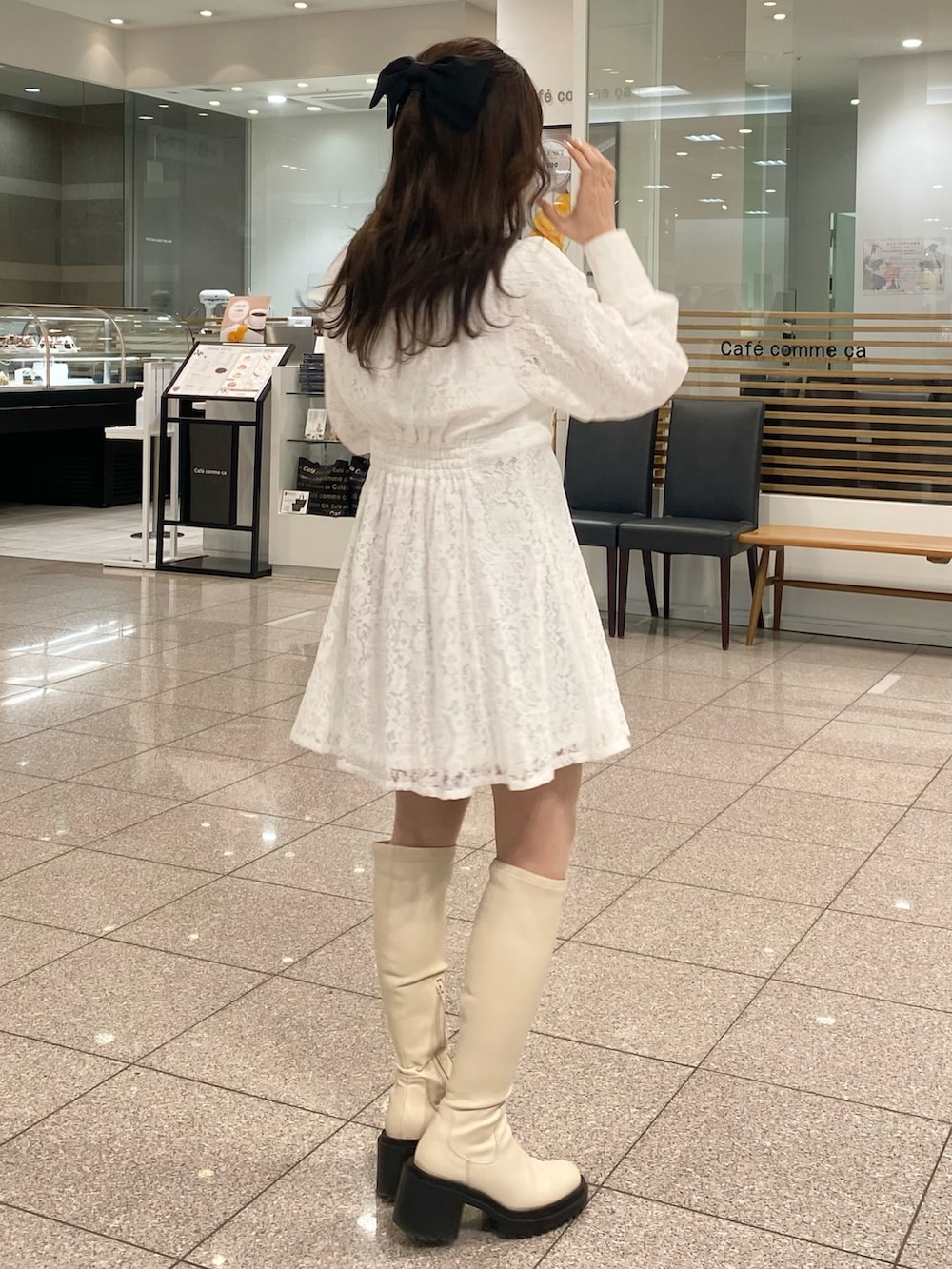 ホワイト系のワンピース、ホワイト系のブーツを着用したレディースの冬コーディネートの3枚目の写真