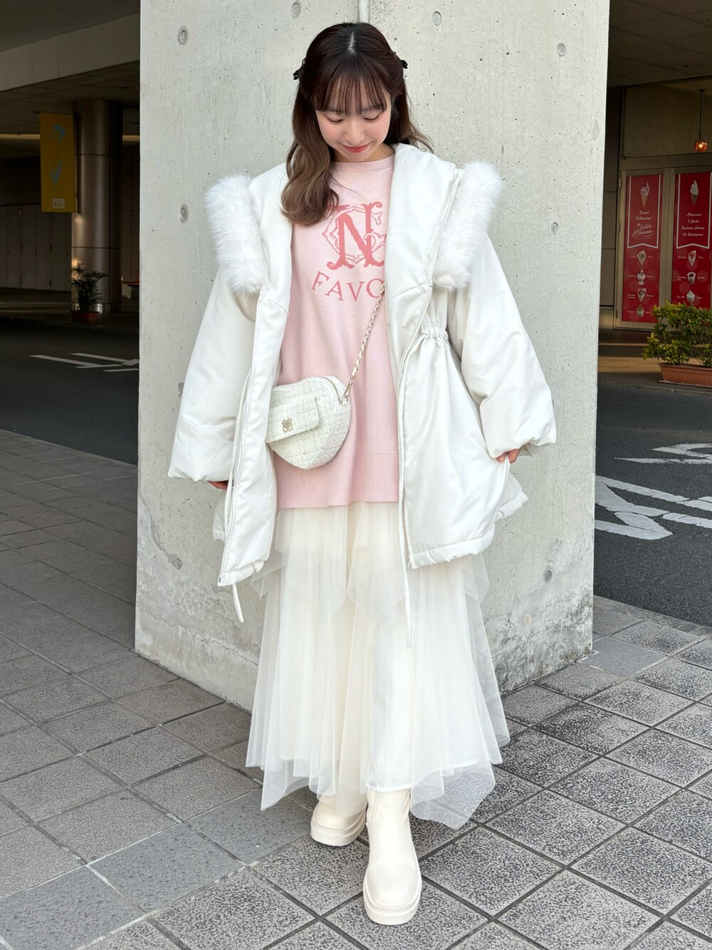 ピンク系のニット/セーター、ホワイト系のスカートを着用したレディースの冬コーディネートの3枚目の写真