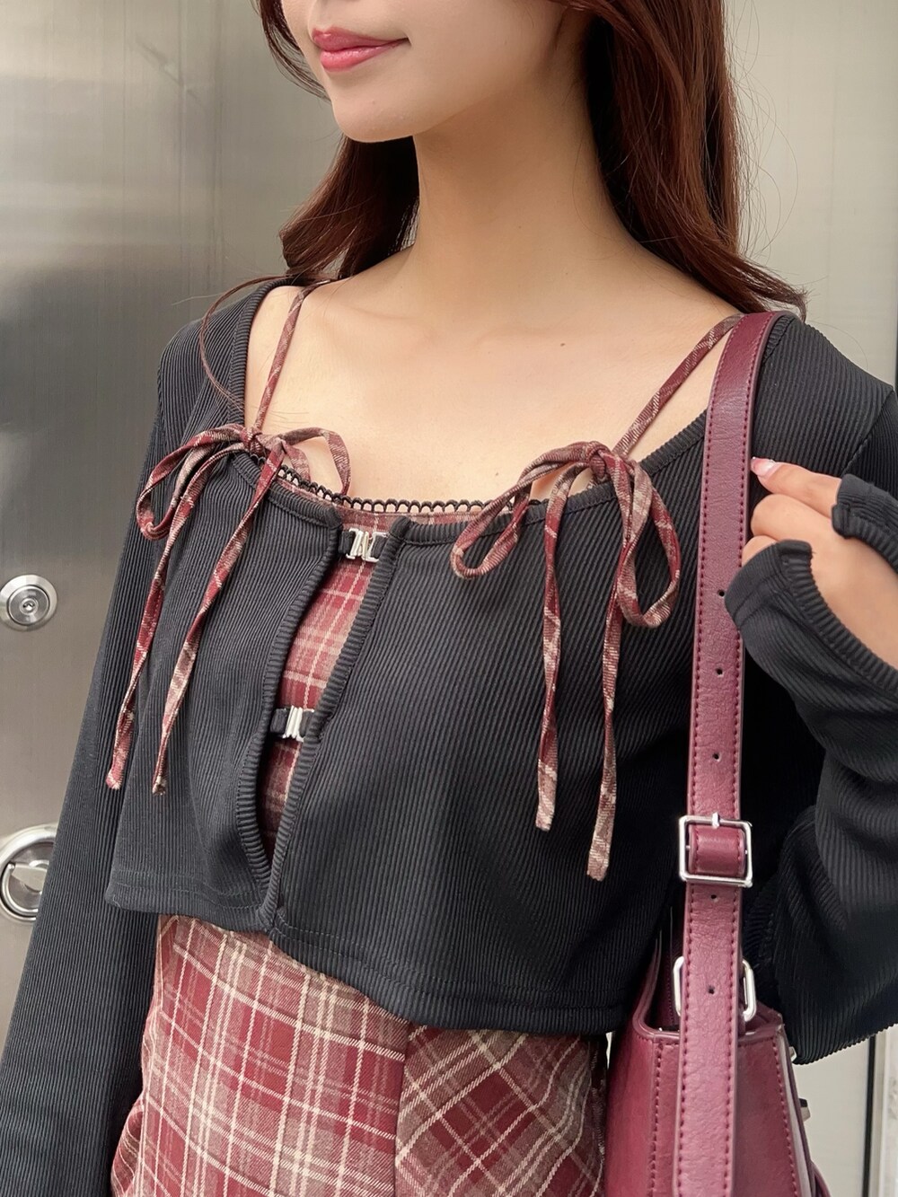 レッド系のワンピース、ブラック系のブーツ、レッド系のショルダーバッグを着用したレディースの秋コーディネートの5枚目の写真