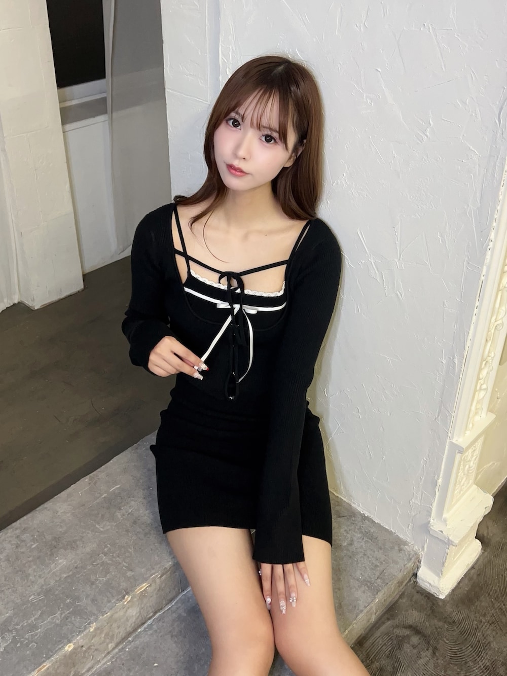 ブラック系のワンピース、ホワイト系のブーツを着用したレディースの冬コーディネートの5枚目の写真