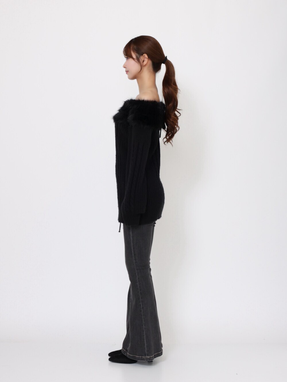 ブラック系のデニムパンツ、ブラック系のブーツ、ブラック系のニット/セーターを着用したレディースの秋コーディネートの3枚目の写真