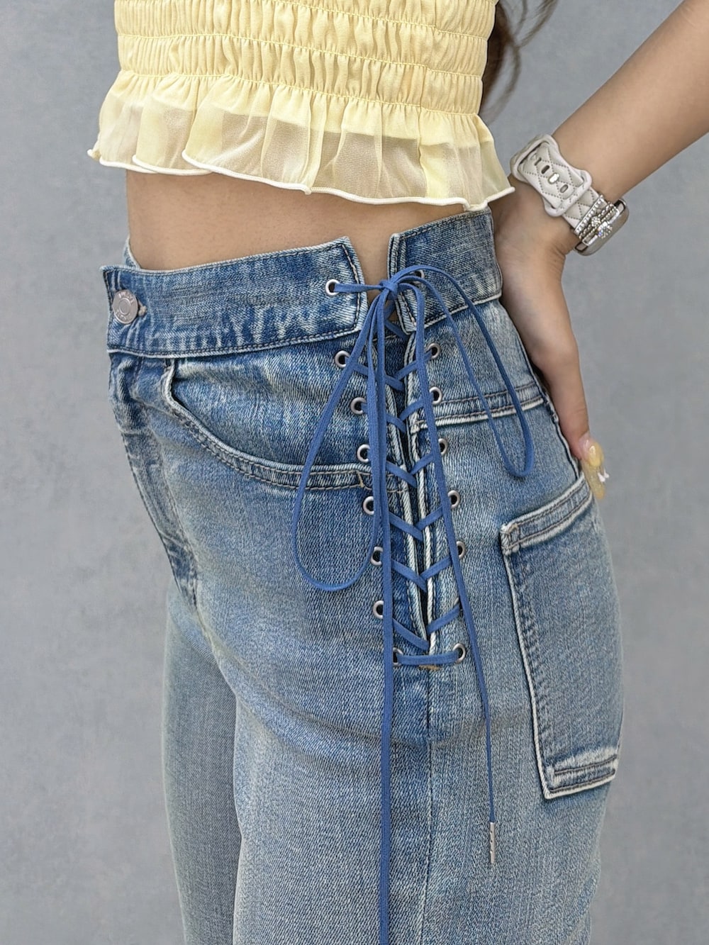 ブルー系のデニムパンツ、イエロー系のシャツ/ブラウス、ホワイト系のサンダルを着用したレディースの春コーディネートの7枚目の写真