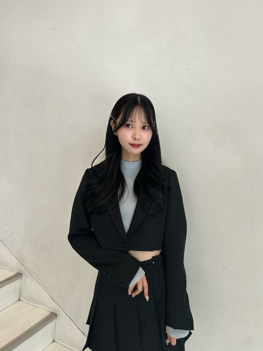 ブラック系のスカート、ブラック系のテーラードジャケット、ブルー系のTシャツ/カットソーを着用したレディースの春コーディネートの3枚目の写真