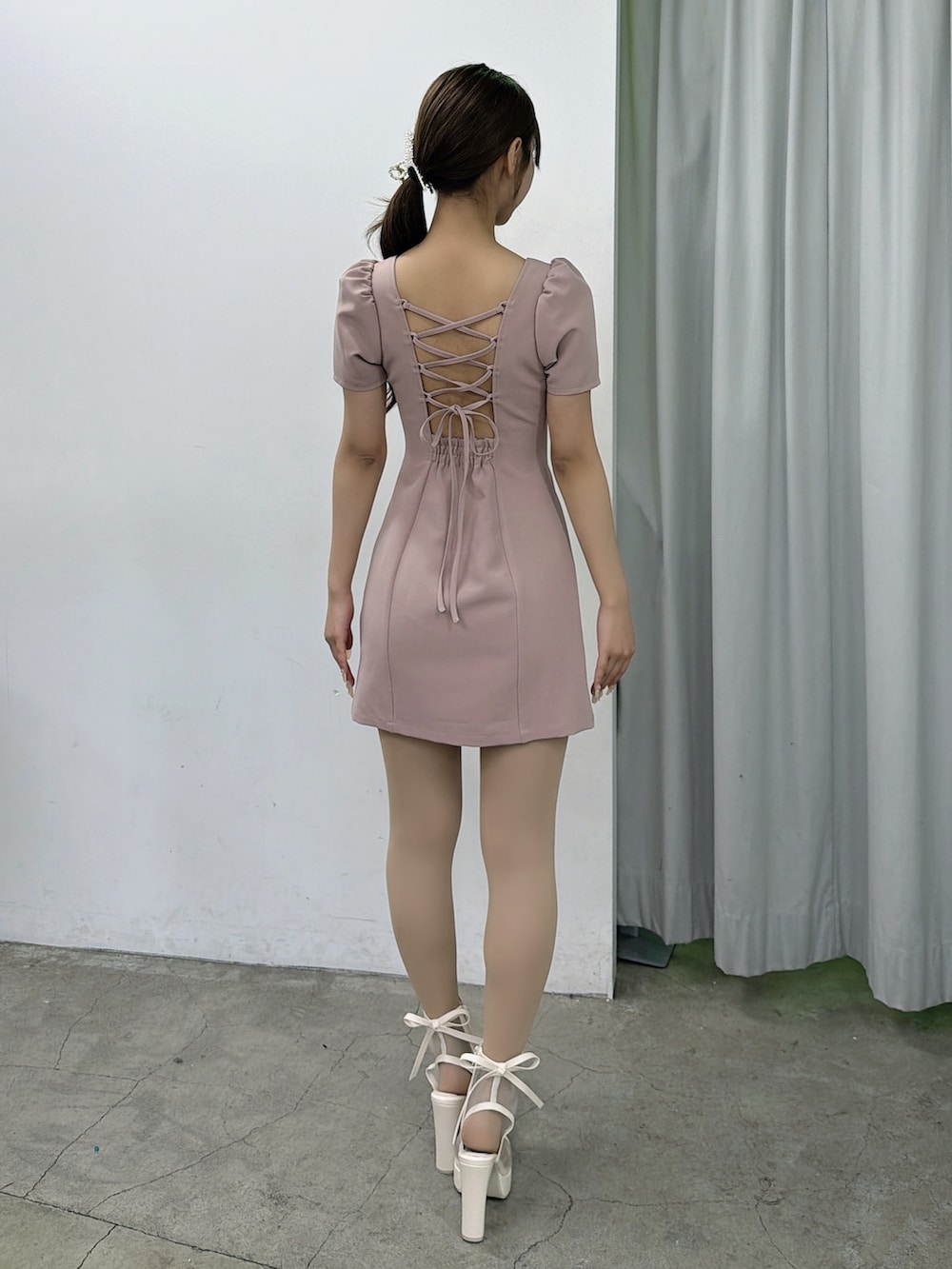 ピンク系のワンピース、ホワイト系のサンダル、ゴールド系のバレッタ/ヘアクリップを着用したレディースの春コーディネートの4枚目の写真