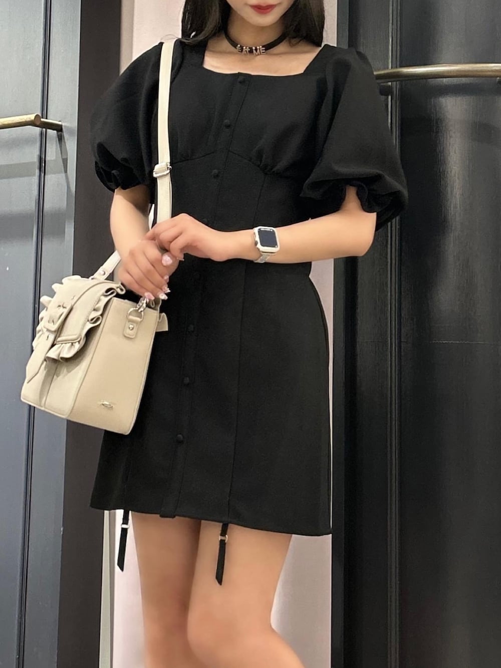 ブラック系のワンピース、ベージュ系のショルダーバッグ、その他のパンプスを着用したレディースの春コーディネートの3枚目の写真