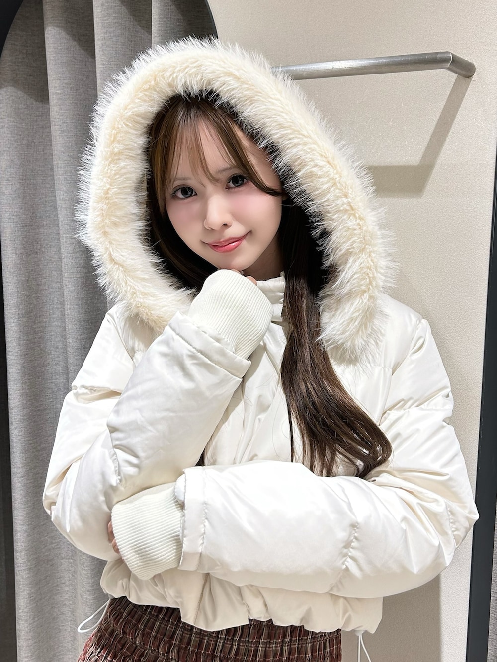 レッド系のワンピース、ホワイト系のブルゾン、ブラウン系のブーツを着用したレディースの秋コーディネートの5枚目の写真