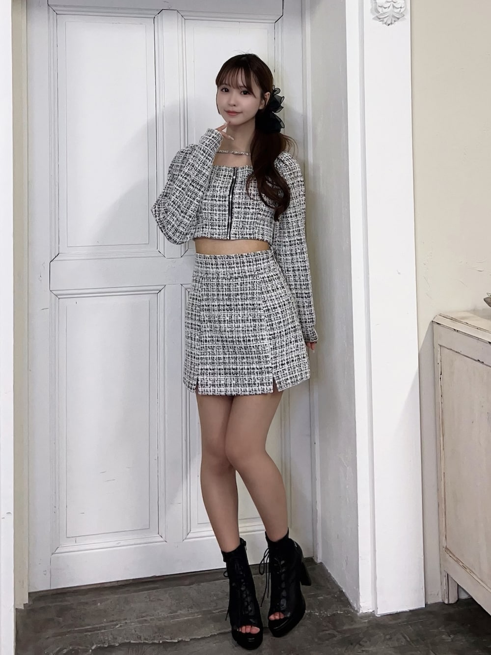 ブラック系のスカート、ブラック系のシャツ/ブラウス、ブラック系のブーツを着用したレディースの春コーディネートの2枚目の写真