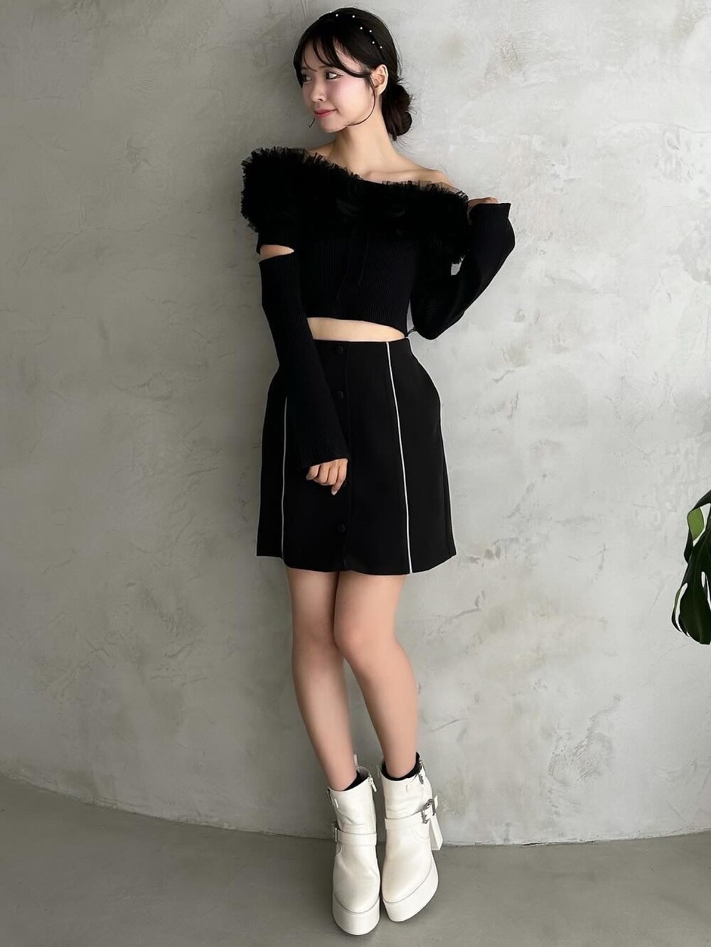 ブラック系のスカート、ブラック系のパンプス、ブラック系のニット/セーターを着用したレディースの秋コーディネートの2枚目の写真