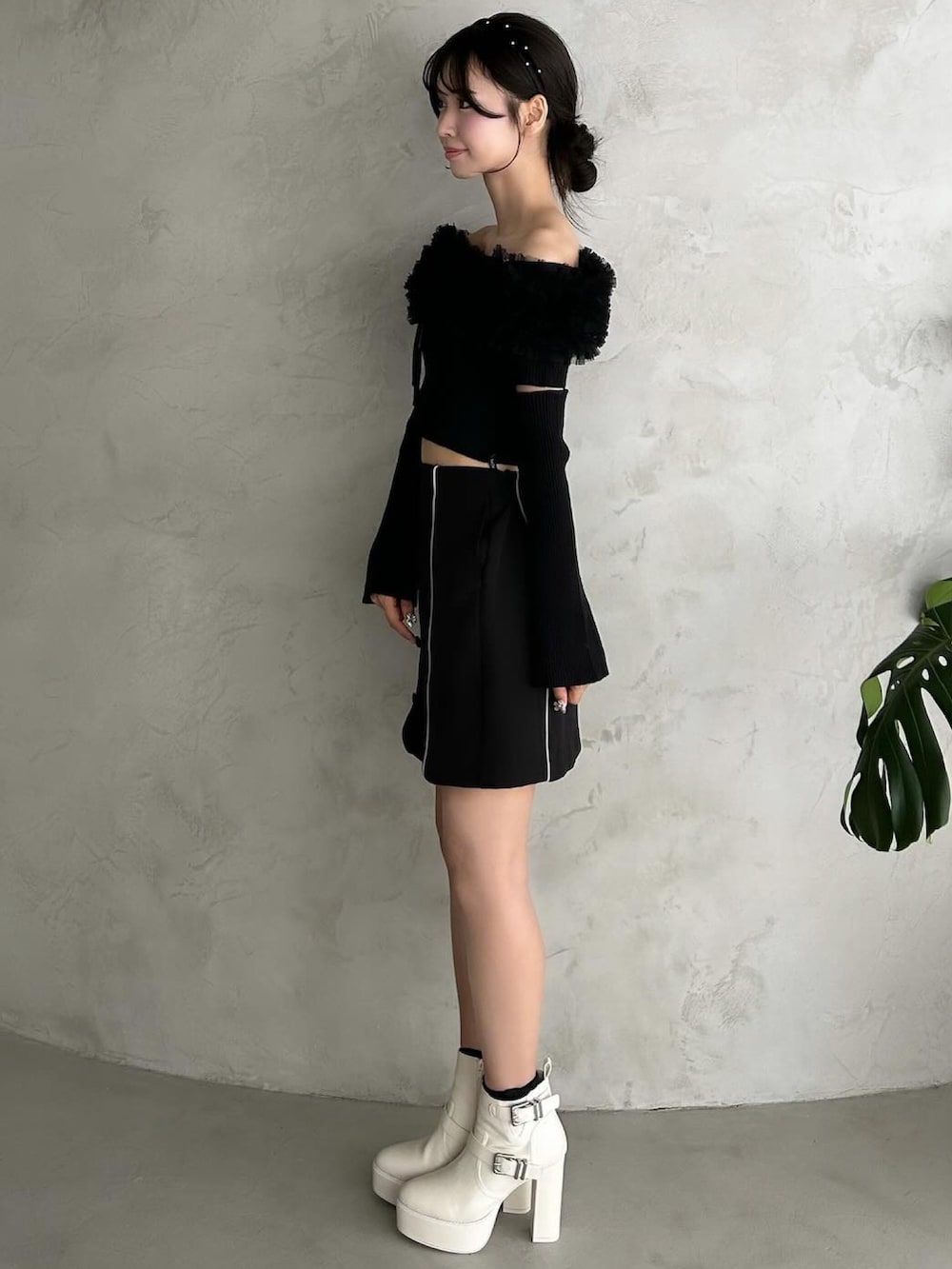 ブラック系のスカート、ブラック系のパンプス、ブラック系のニット/セーターを着用したレディースの秋コーディネートの3枚目の写真