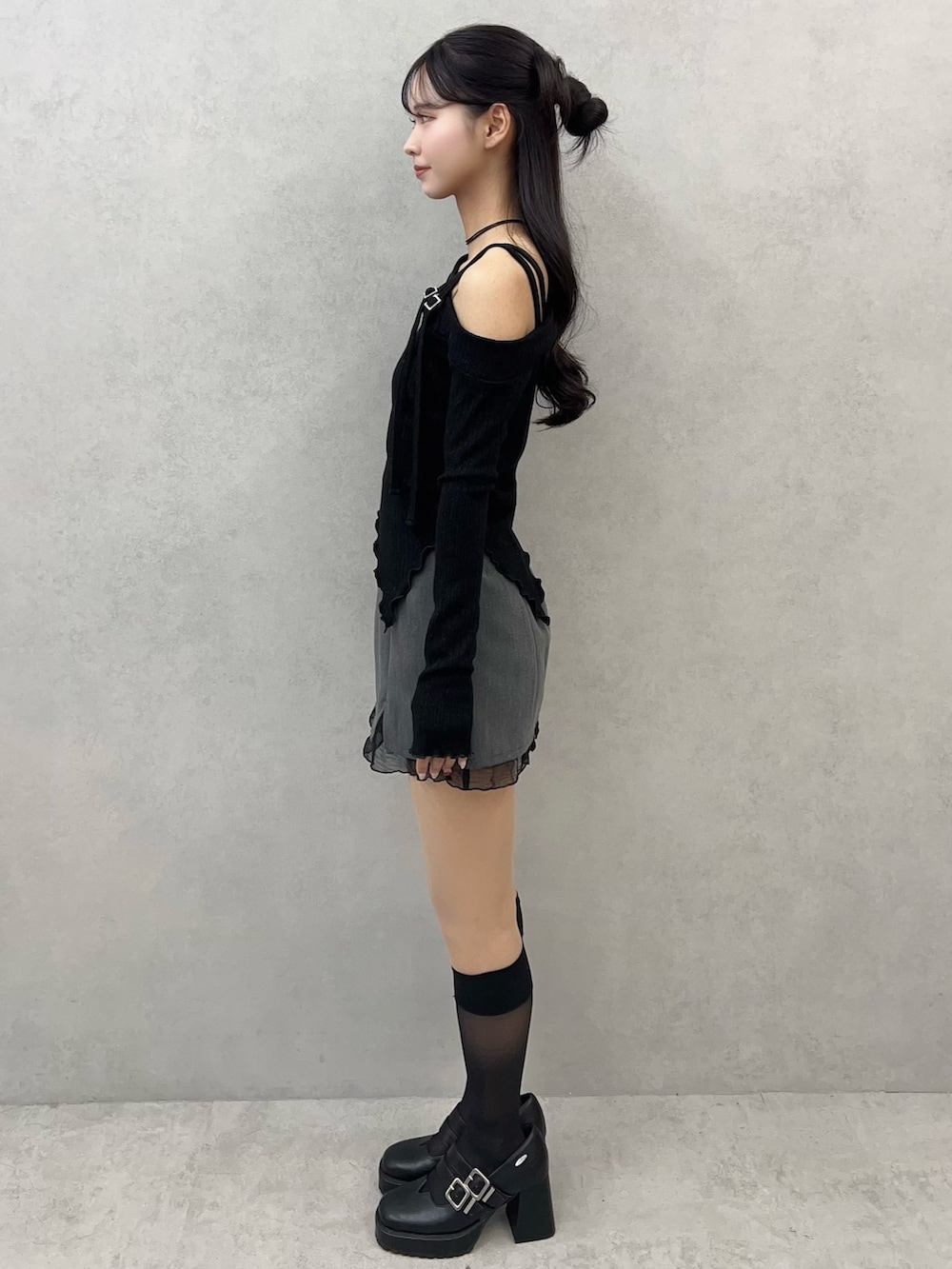 ブラック系のTシャツ/カットソー、グレー系のスカート、ブラック系のパンプスを着用したレディースの冬コーディネートの4枚目の写真