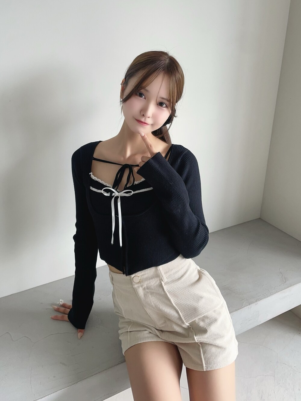 ホワイト系のその他パンツ、ブラック系のニット/セーター、ブラック系のブーツを着用したレディースの秋コーディネートの6枚目の写真