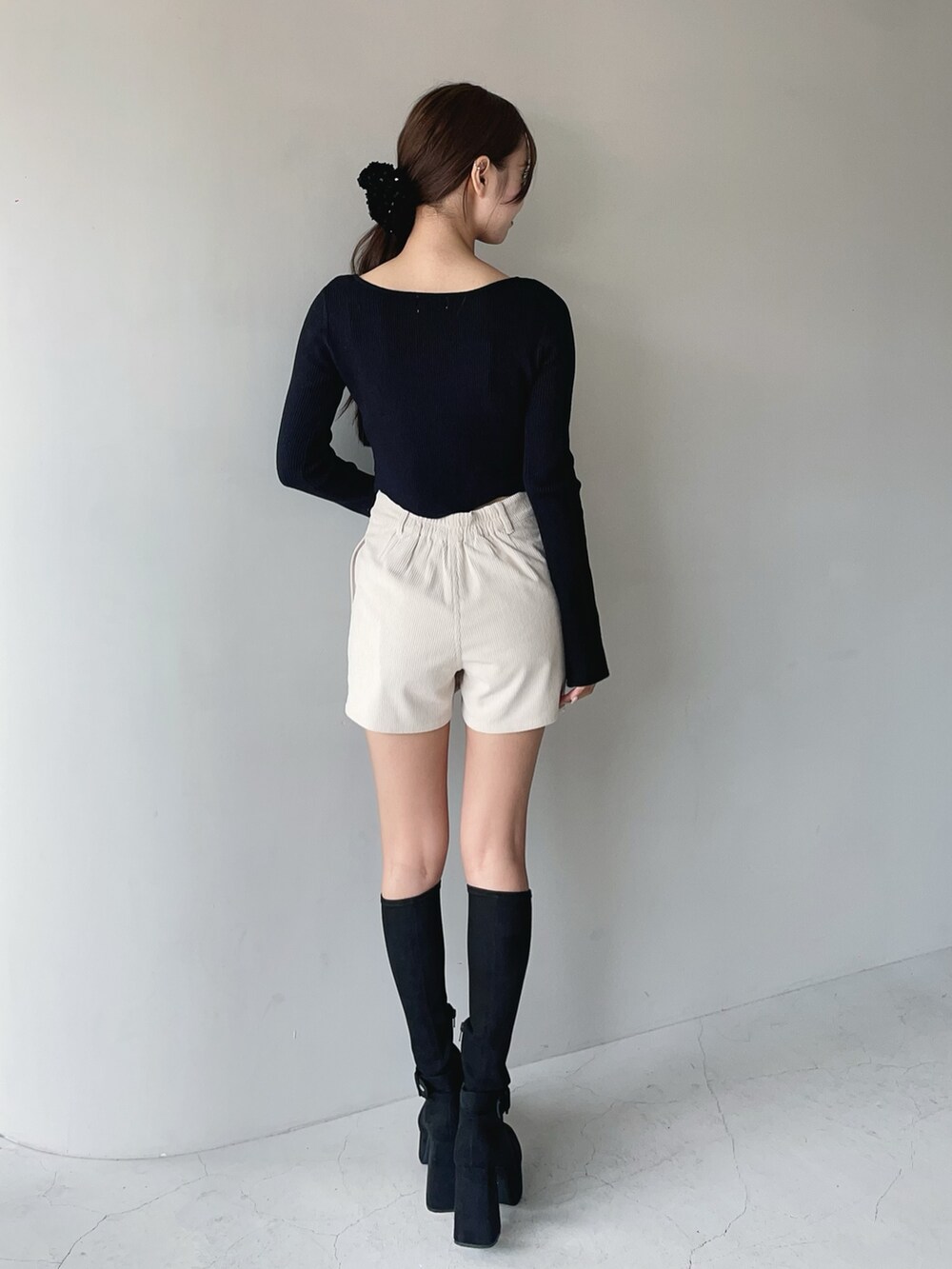 ホワイト系のその他パンツ、ブラック系のニット/セーター、ブラック系のブーツを着用したレディースの秋コーディネートの4枚目の写真