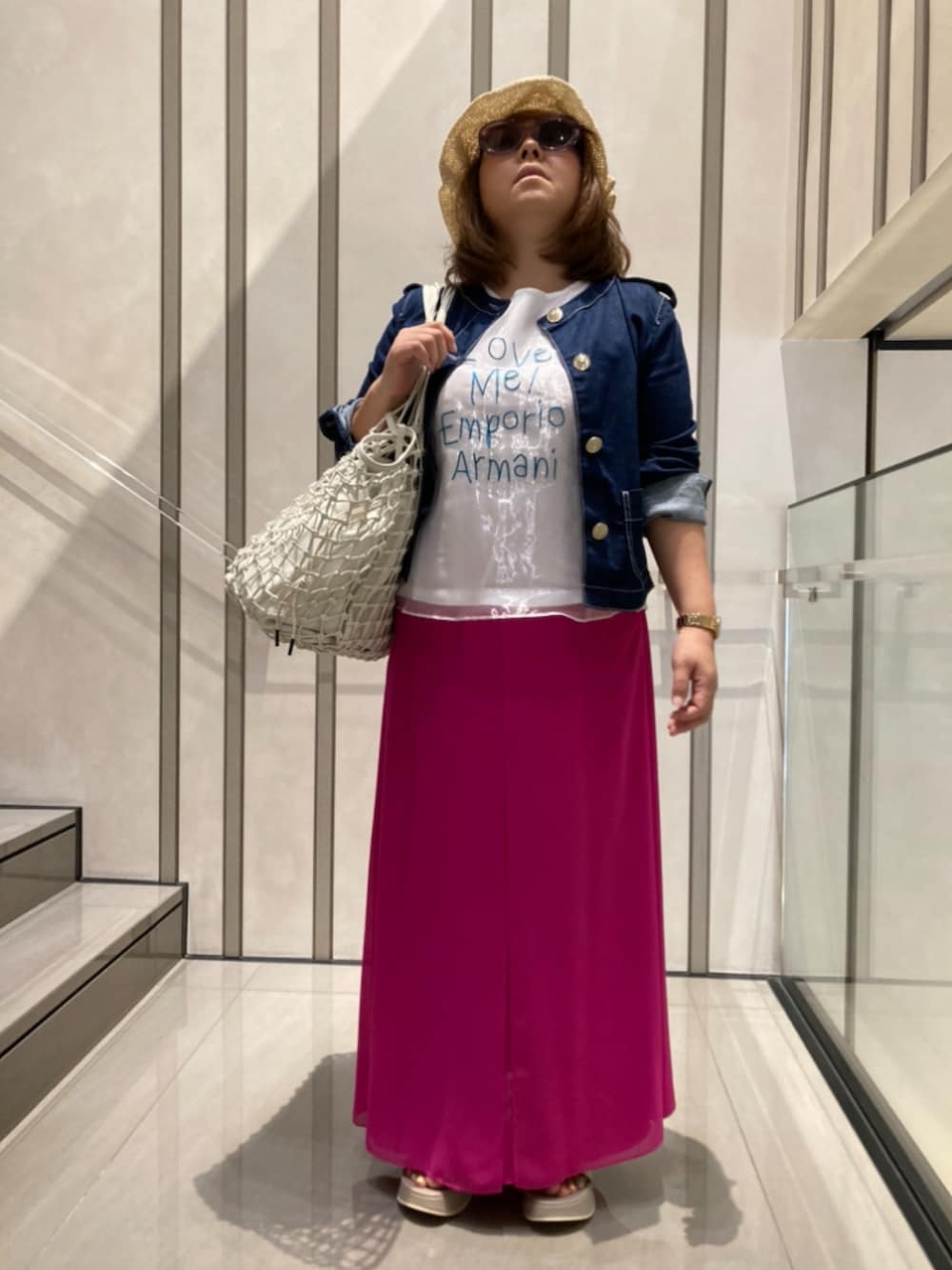 ベージュ系のトートバッグを着用したレディースの夏コーディネートの2枚目の写真