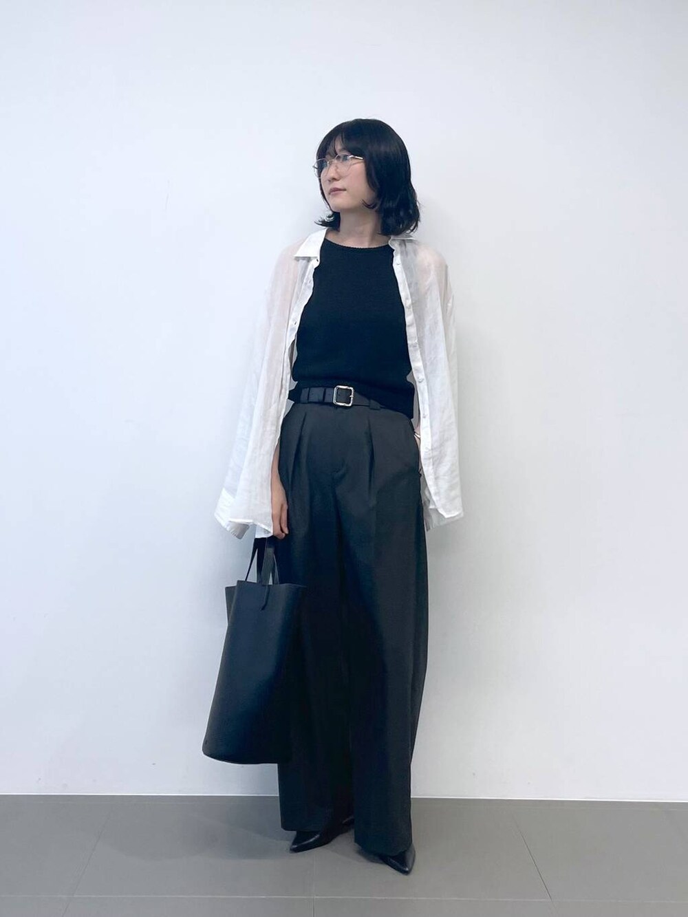 ブラック系のタンクトップ、ホワイト系のシャツ/ブラウス、ブラック系のトートバッグを着用したレディースの夏コーディネートの2枚目の写真