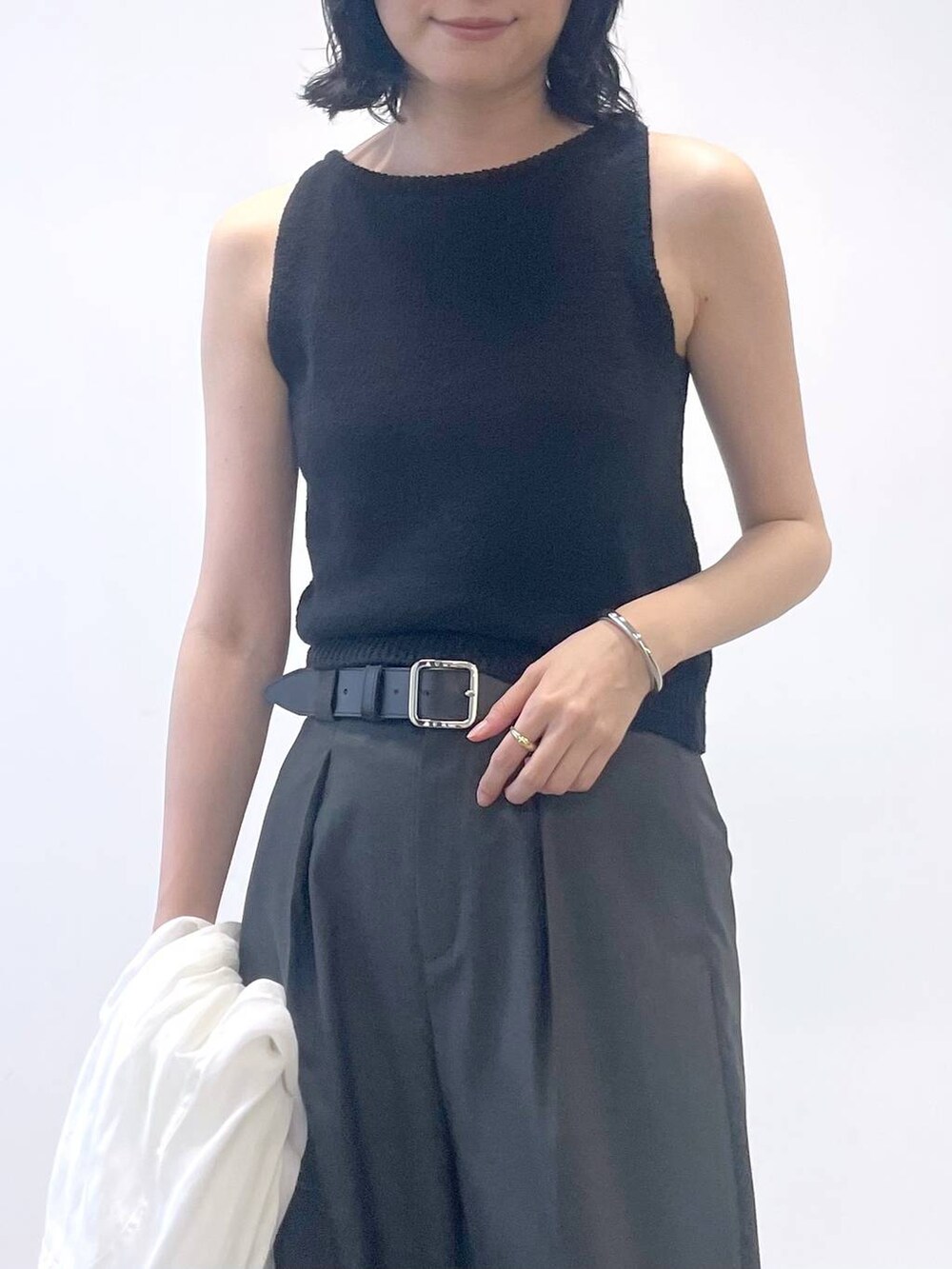 ブラック系のタンクトップ、ホワイト系のシャツ/ブラウス、ブラック系のトートバッグを着用したレディースの夏コーディネートの5枚目の写真