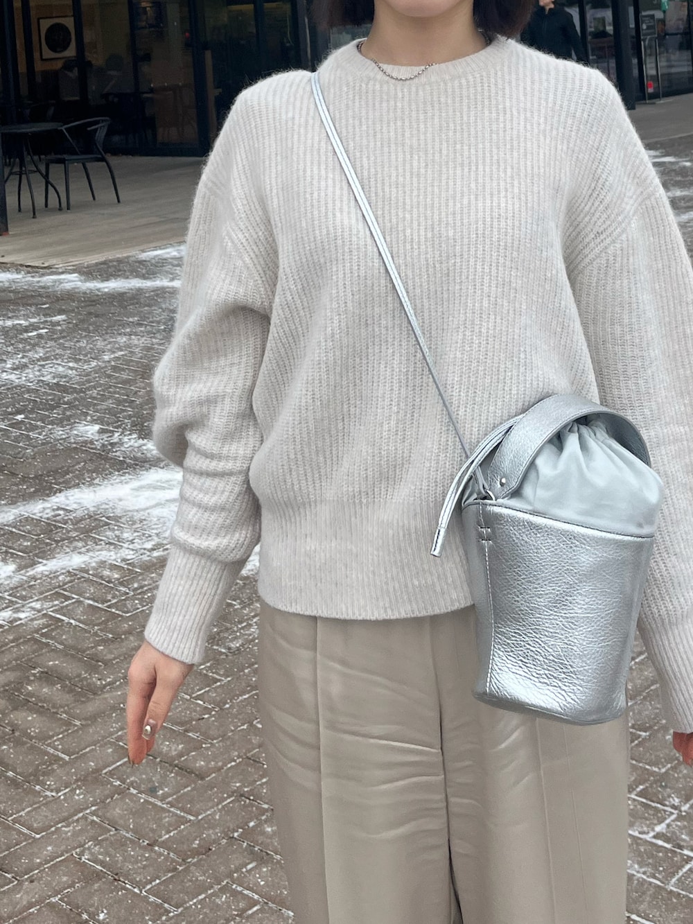 ホワイト系のその他パンツ、ホワイト系のニット/セーター、ホワイト系のローファーを着用したレディースの冬コーディネートの2枚目の写真