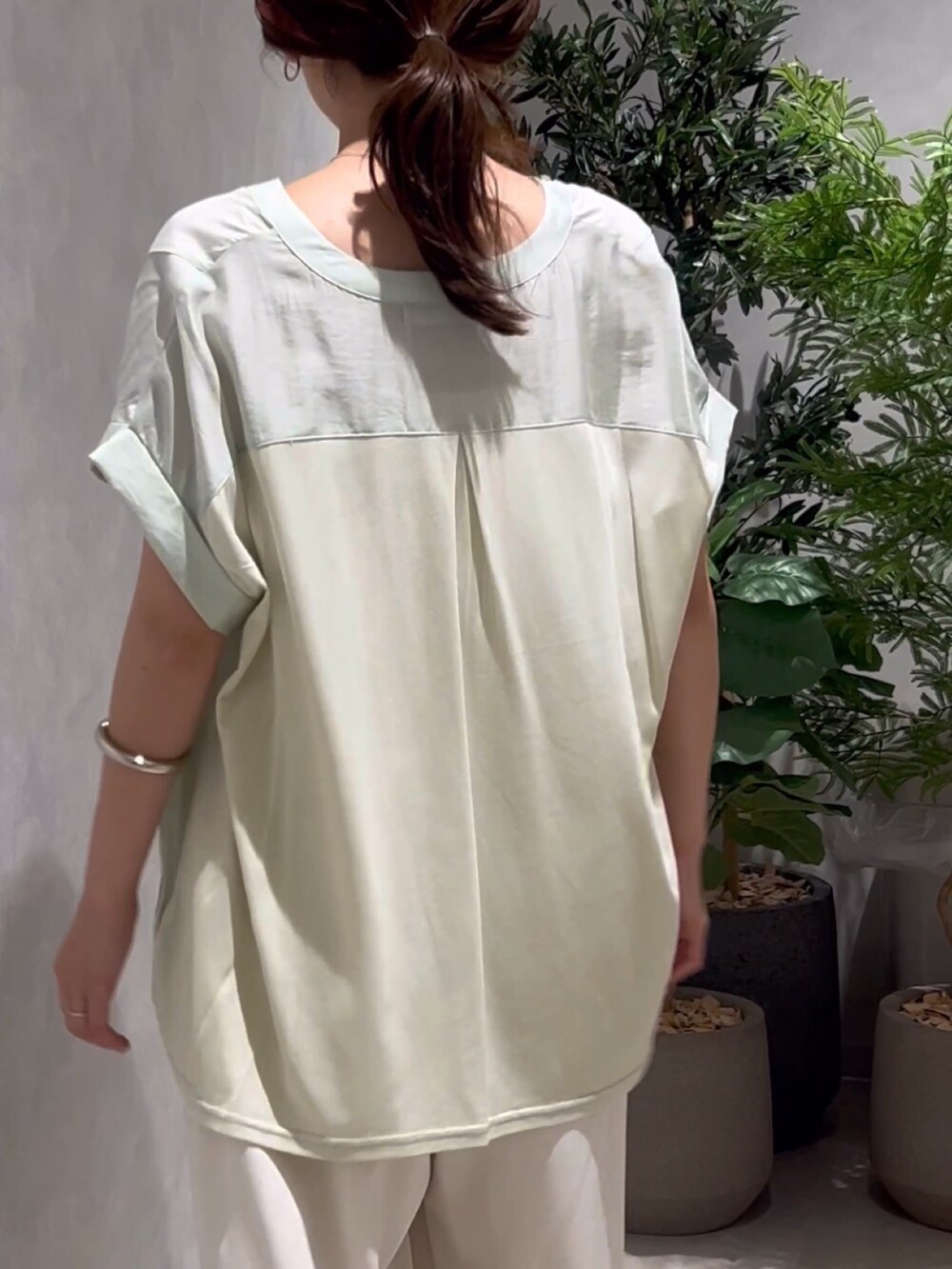 グリーン系のシャツ/ブラウスを着用したレディースの夏コーディネートの3枚目の写真