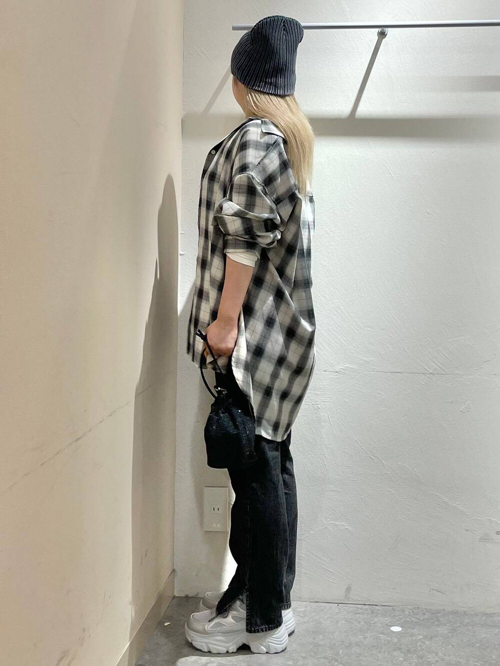 ホワイト系のシャツ/ブラウス、ブラック系のデニムパンツ、シルバー系のスニーカーを着用したレディースの夏コーディネートの4枚目の写真