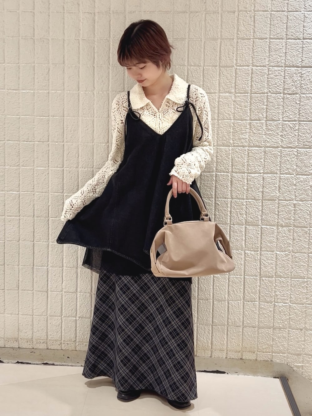 ホワイト系のニット/セーター、ブラック系のワンピース、ブルー系のスカートを着用したレディースの冬コーディネートの3枚目の写真