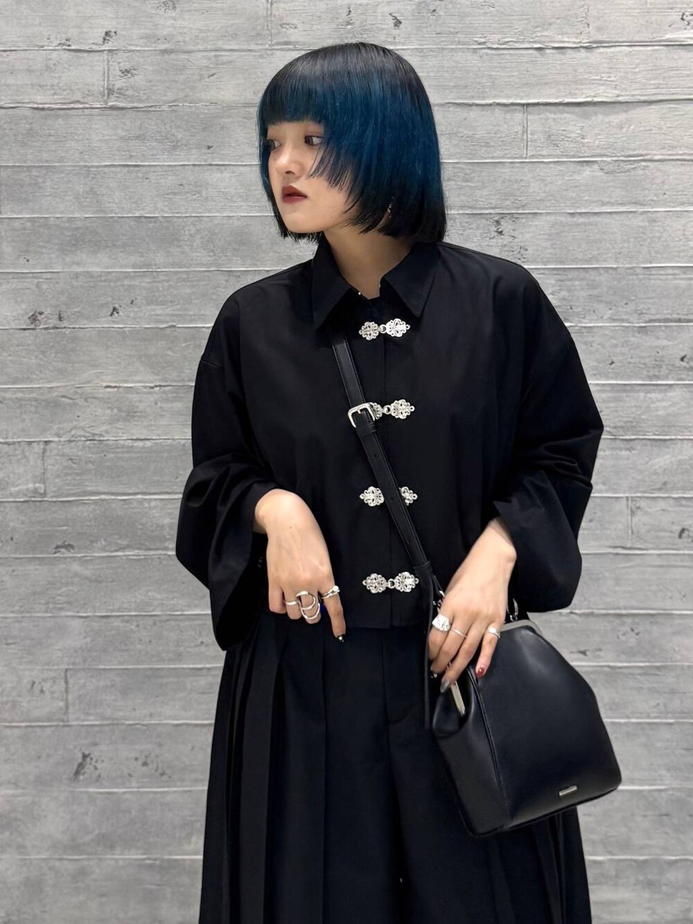 ブラック系のシャツ/ブラウス、グレー系のブーツ、ブラック系のショルダーバッグを着用したレディースの秋コーディネートの6枚目の写真