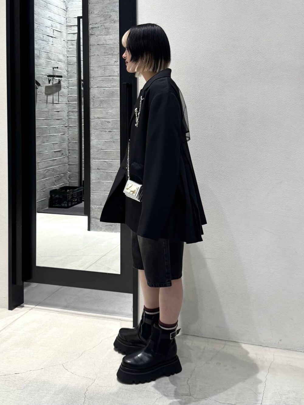 ブラック系のブーツ、グレー系のデニムパンツ、ブラック系のカーディガン/ボレロを着用したレディースの冬コーディネートの4枚目の写真